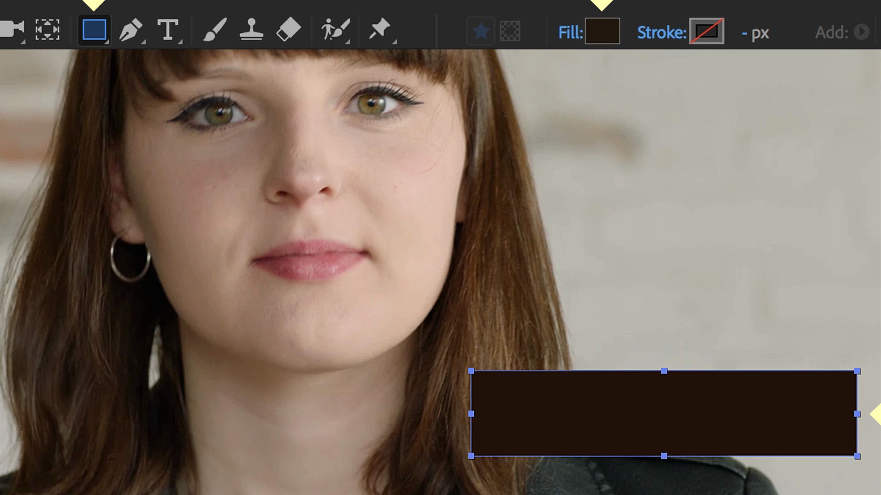 A rectangle is placed in the lower third right hand corner of the woman’s portrait.