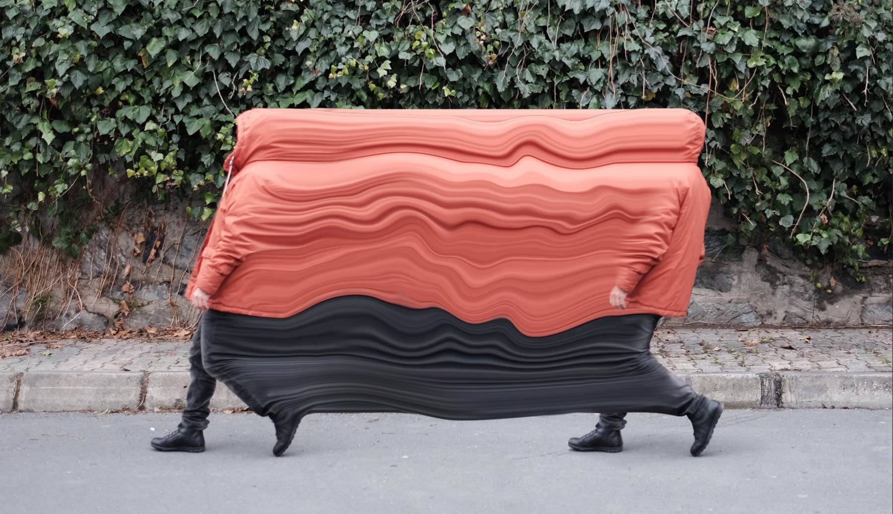 The two figures now appear to be joined together by the orange coat and black pants stretched between them