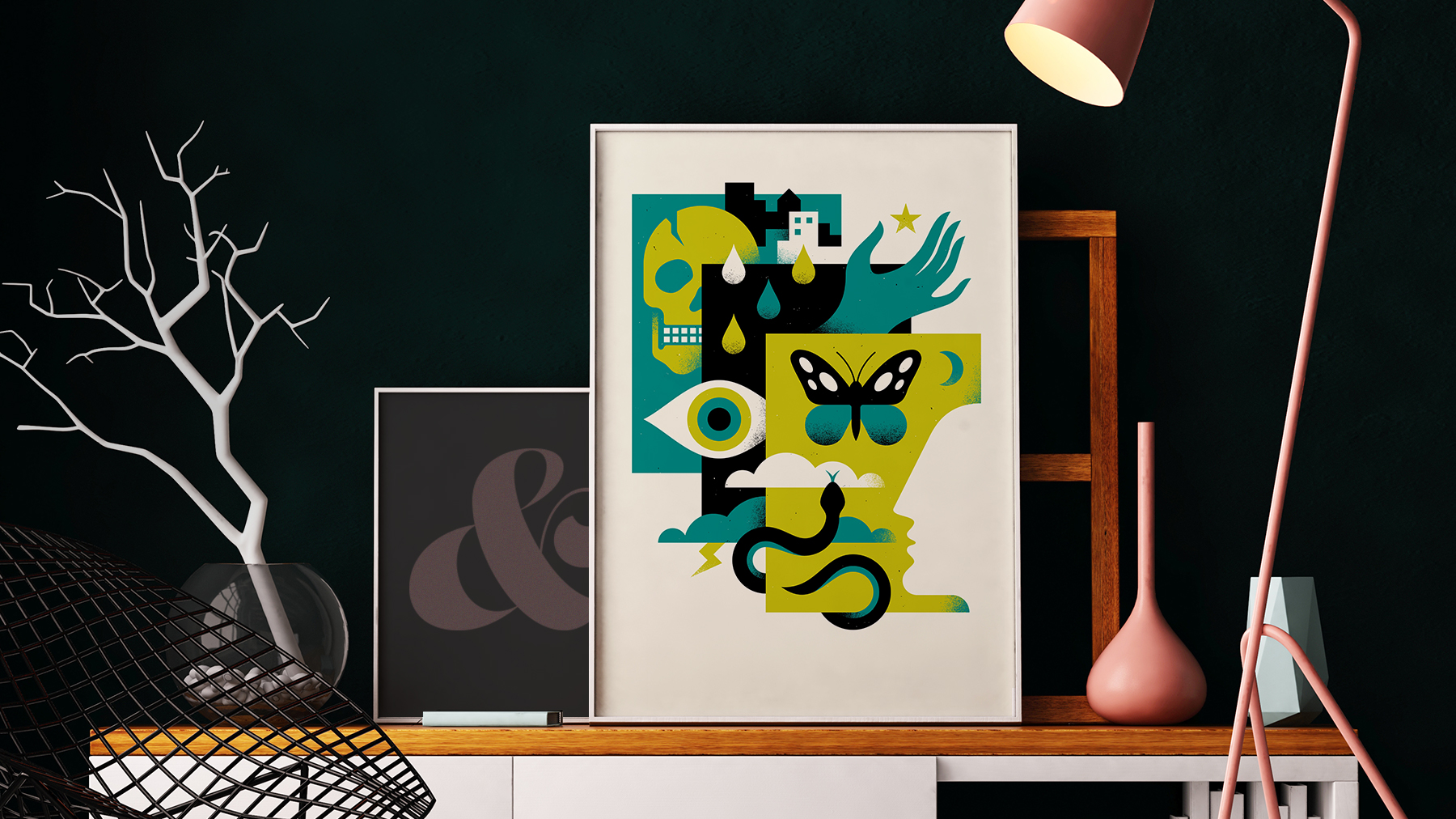 A photo of a living room setting, with framed posters on display. The poster artwork is by Doublenaut Design for The National Poster Retrospecticus and depicts a geometric illustration containing a skull, snake, butterfly, hand, eye, and the silhouette of a person's face.