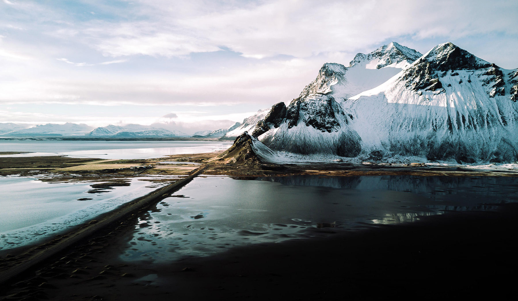 After: Adjusted arctic mountain on a beach. Sky is colorful, colors are vibrant, and details stand out. After: Adjusted arctic mountain on a beach. Sky is colorful, colors are vibrant, and details stand out.