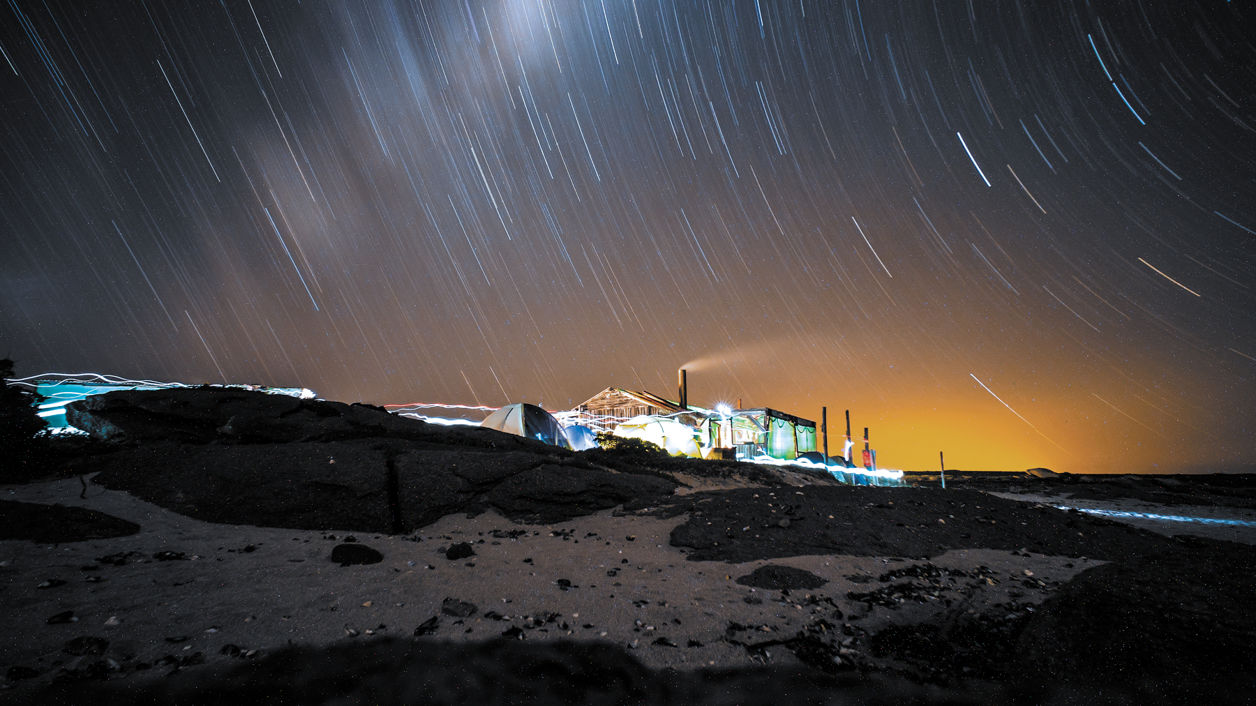 After image shows tents on a beach at night with orange hues corrected and blue tones added to the sky. After image shows tents on a beach at night with orange hues corrected and blue tones added to the sky.