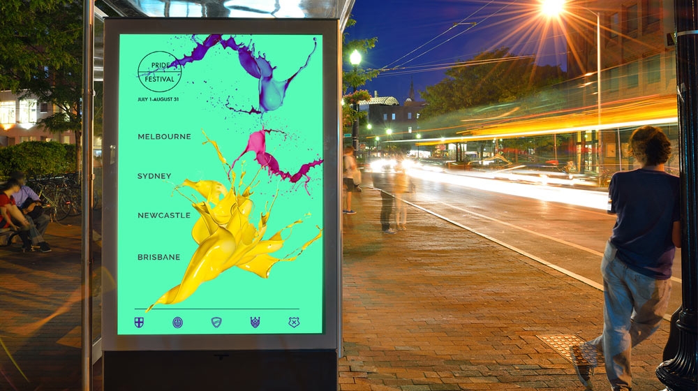 Sea green Australia Pride Festival poster with purple, pink, and yellow paint splashes hangs on bus stop wall Sea green Australia Pride Festival poster with purple, pink, and yellow paint splashes hangs on bus stop wall