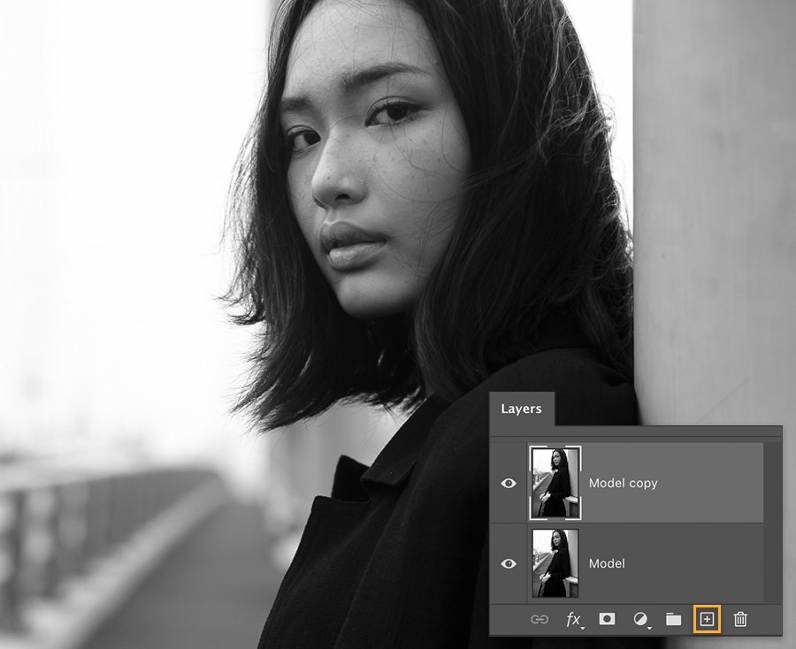 Black and white photo of model with Photoshop Layers panel showing two layers – ‘model’ and ‘model copy’ Black and white photo of model with Photoshop Layers panel showing two layers – ‘model’ and ‘model copy’