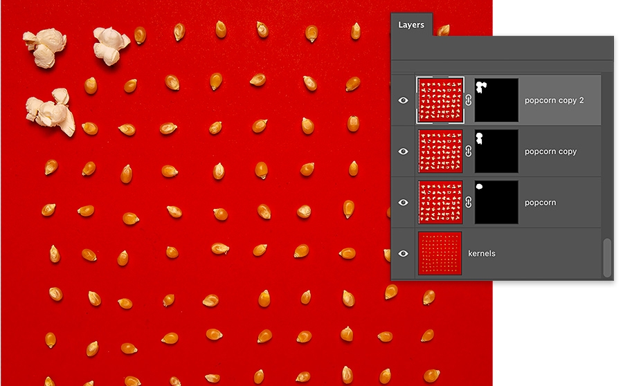 3 kernels of popcorn on red background are popped, remaining kernels are un popped, photoshop layers panel has 4 layers, 3 with layer mask 3 kernels of popcorn on red background are popped, remaining kernels are un popped, photoshop layers panel has 4 layers, 3 with layer mask