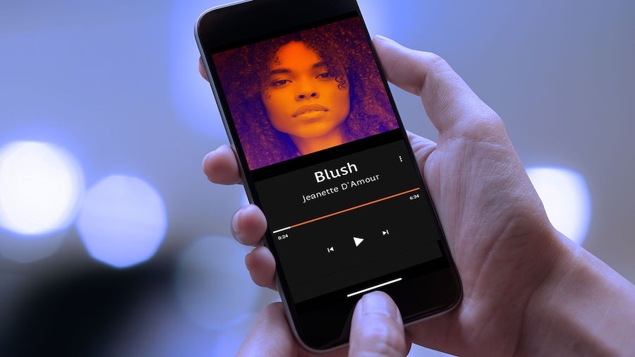 Mobile phone displays purple and orange duotone portrait of a woman. Mobile phone displays purple and orange duotone portrait of a woman.