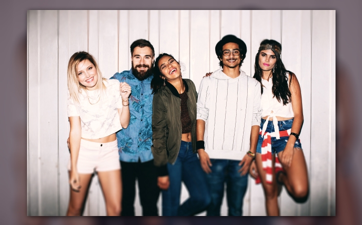 Image des trois jeunes femmes et des deux jeunes hommes lors d’une fête retouchée pour réchauffer les tons et flouter le haut et le bas